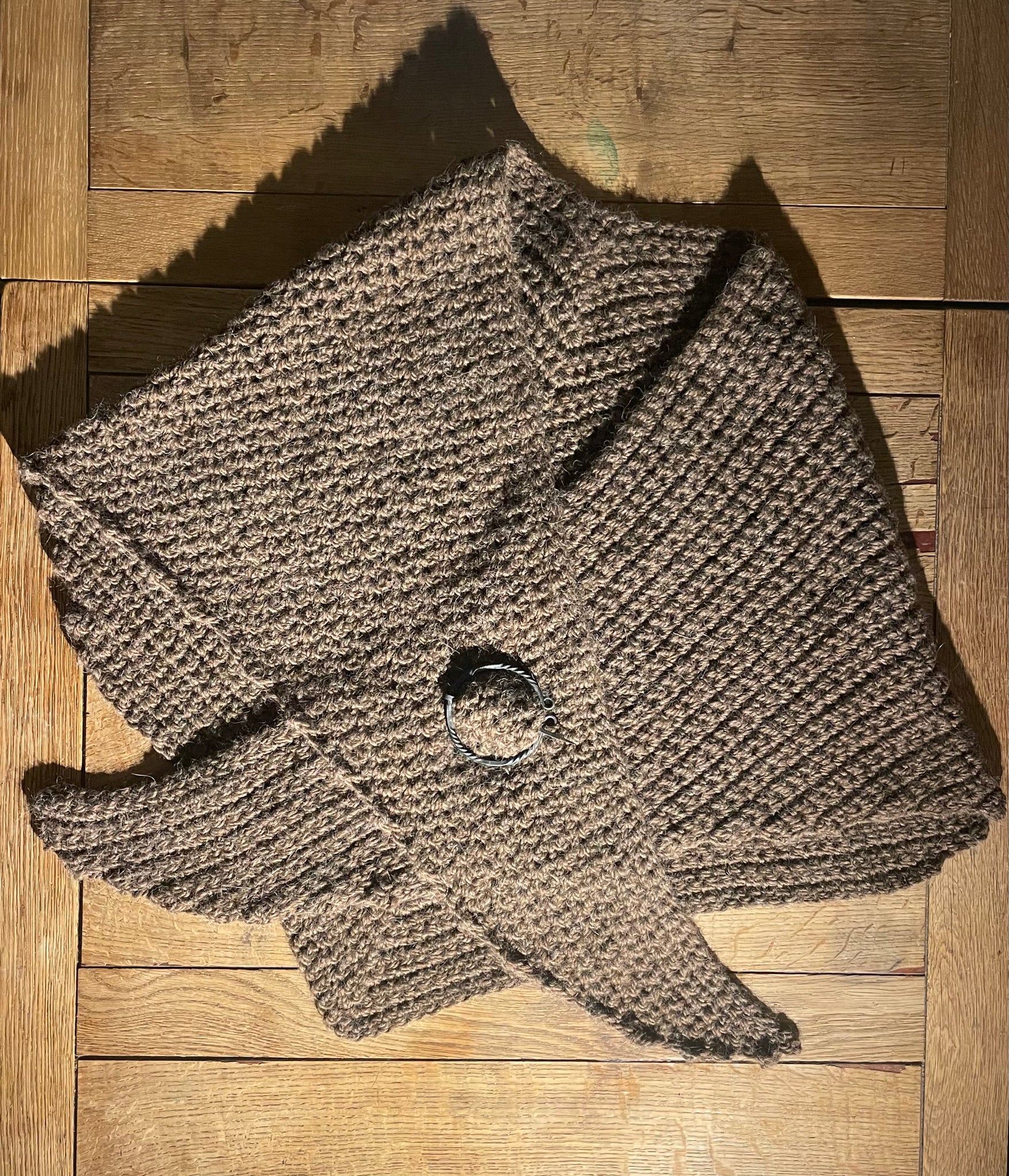 Warm brown hand crocheted pure wool and alpaca shawl with hand forged cloak pin.