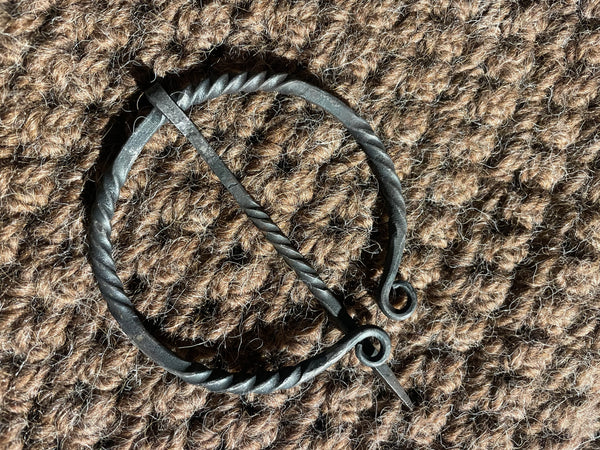 Warm brown hand crocheted pure wool and alpaca shawl with hand forged cloak pin.